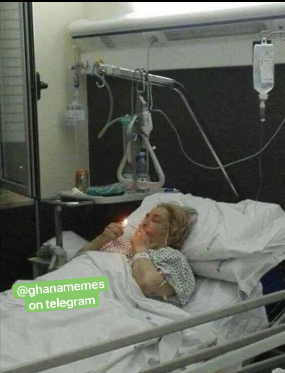 a woman laying in a hospital bed with a drip drip